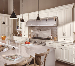 This Classic White transitional kitchen design has an L-shaped kitchen island in Dura Supreme’s Latte paint finish.